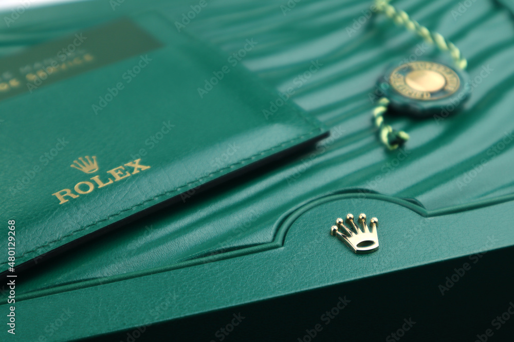 The Rolex green leather box with golden logo is displayed on the in the watch shop Stock Photo | Adobe Stock