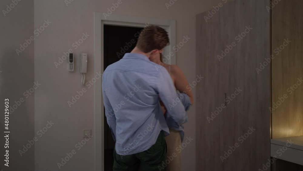couple in love man and woman in casual clothes kiss passionately at home go to bed. couple in love man and woman in casual clothes kiss passionately at home go to bed.
