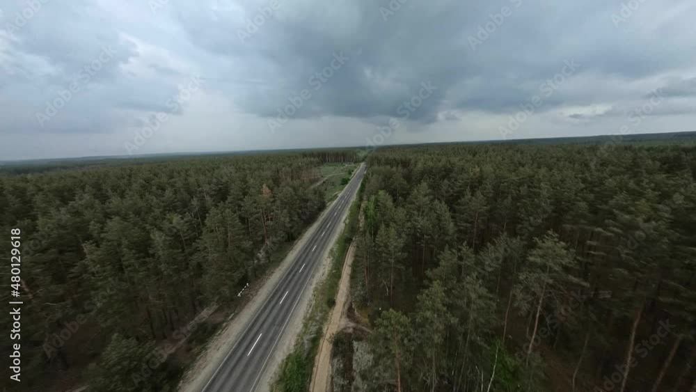 FPV flight over a road in the forest with cut down areas on a cloudy day FPV flight over a road in the forest with cut down areas on a cloudy day