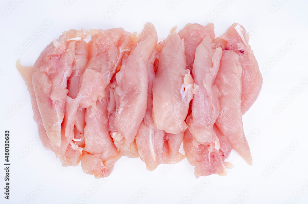 Slices of small chicken fillet on white background. Studio Photo Slices of small chicken fillet on white background. Studio Photo