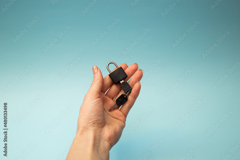 Fototapeta premium Girl holding a lock with a key