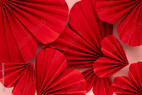 Elegant luxury Valentine day background with bright passion red paper origami hearts as pattern  texture  closeup  top view.