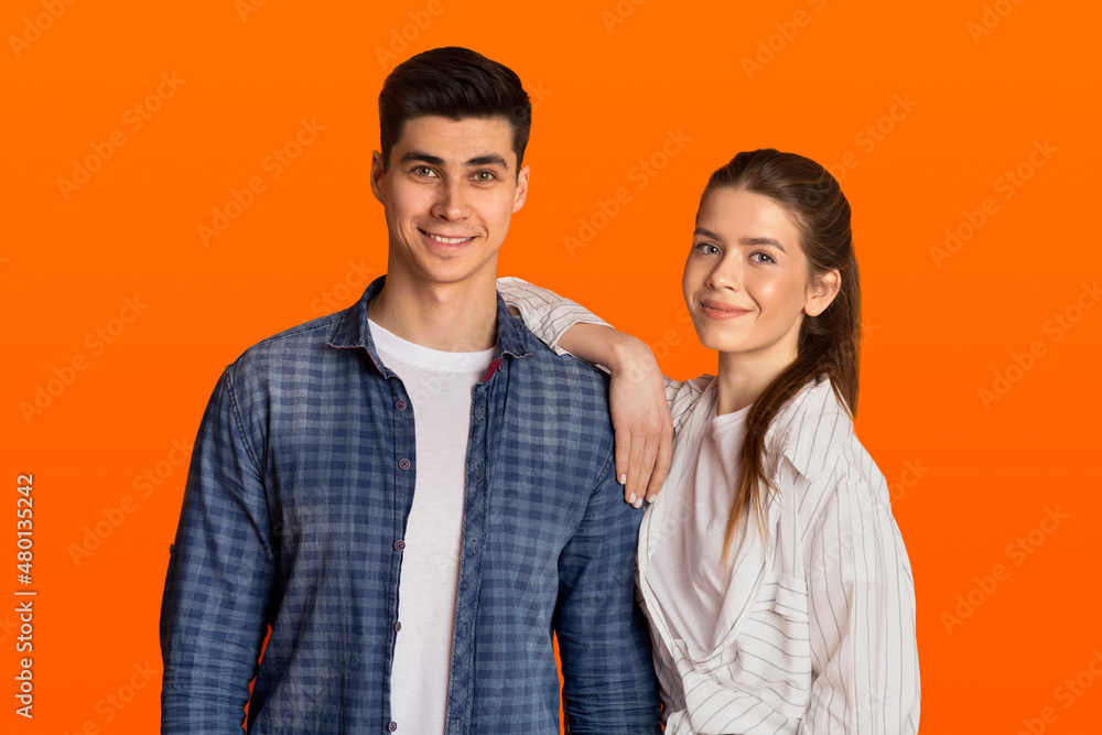 Smiling young attractive guy and woman in casual look at camera Smiling young attractive guy and woman in casual look at camera
