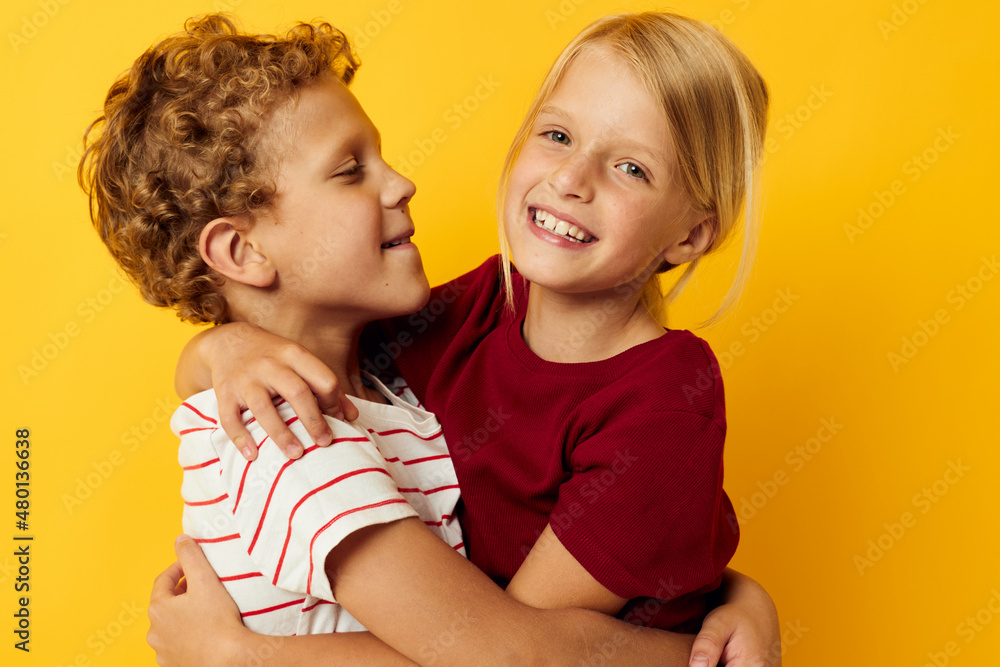 Cute preschool kids standing side by side posing childhood emotions yellow background Cute preschool kids standing side by side posing childhood emotions yellow background