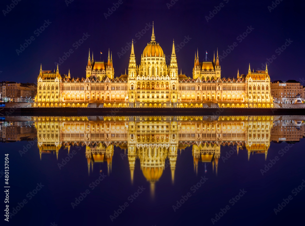 Hungarian Parliament building at night with reflection in Danube river, Budapest, Hungary