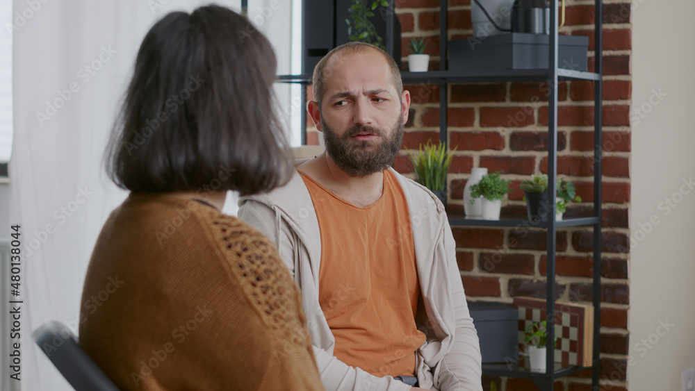 Close up of man and woman having discussion about addiction at aa therapy session. People attending rehabilitation meeting and trying to cure mental health problems. Rehab program Close up of man and woman having discussion about addiction at aa therapy session. People attending rehabilitation meeting and trying to cure mental health problems. Rehab program