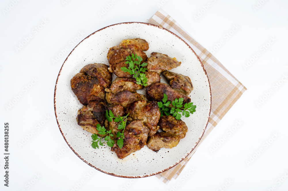 Cooked chicken liver on plate. Liver dishes. Studio Photo