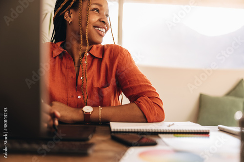 Female designer smiling in her office photo