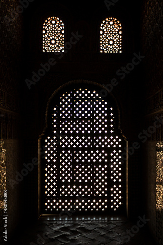 Arabic window on Comares Tower in Alhambra, Granada, Spain. A low key picture of a silhouette.