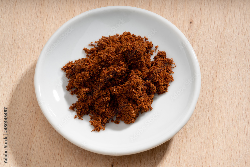 Detailed and large close up shot of powdered star anise on a small plate Detailed and large close up shot of powdered star anise on a small plate