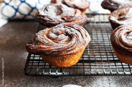 Chocolate cruffin, a hybrid of a croissant and muffin with a lot of butter, sprinkled with powdered sugar.