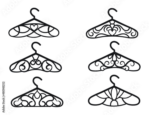 Set of decorative hangers. Collection of silhouettes of stylized  openwork hangers for clothes, atelier, wedding salon. Wardrobe hangers in vintage style. Vector illustration on white background.