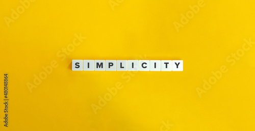 Simplicity Word and Banner. Letter tiles on bright orange background. Minimal aesthetics. photo