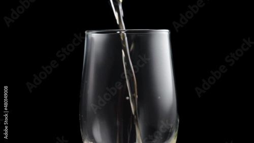 Beer is poured into the glass, the foam slowly drains down the walls of the glass. Slow motion