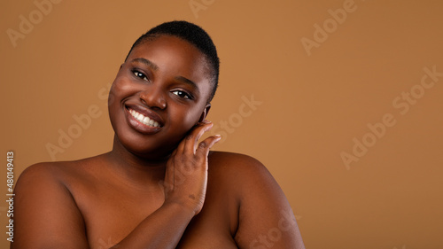 Beautiful plus size African american woman posing looking at camera