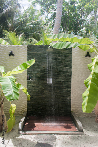 An amazing outdoor shower near the ocean  in a resort hotel on an exotic tropical island.  Maldives. A heavenly place to relax. Tourism, travel. 