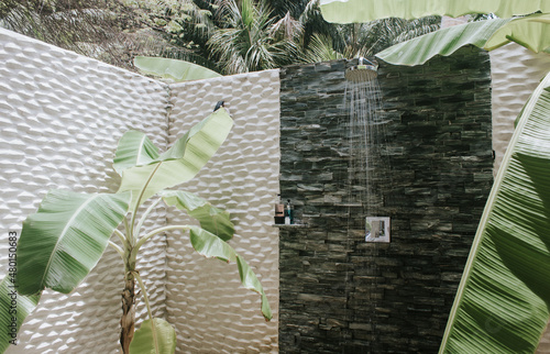Amazing outdoor shower with banana trees growing inside in a resort hotel bungalow on an exotic tropical island. Maldives. Paradise place to relax. Tourism, travel. 