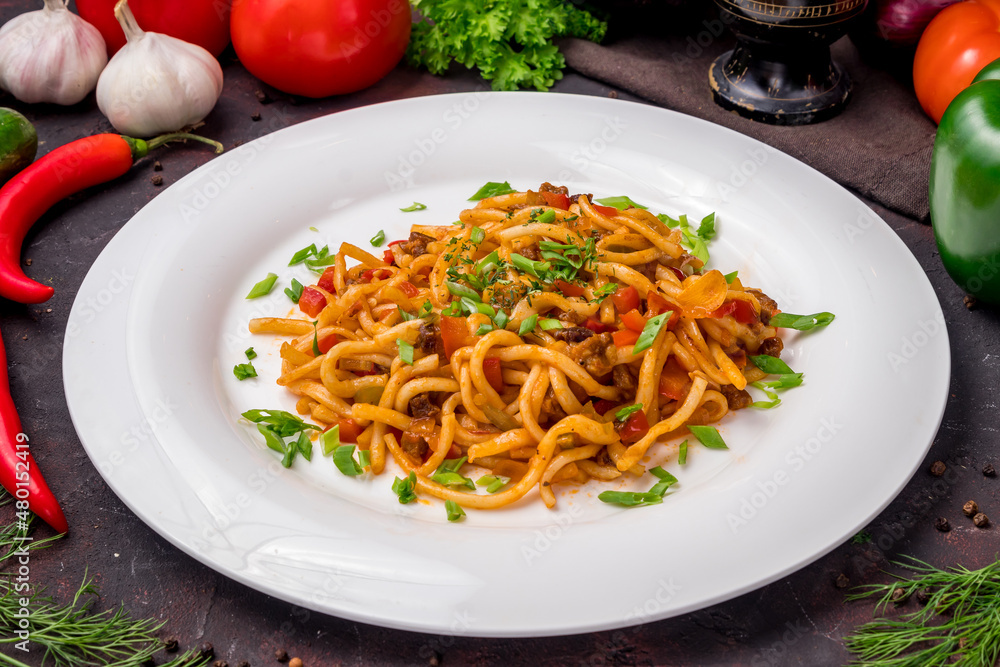 fried lagman on plate with beef and noodles od dark table fried lagman on plate with beef and noodles od dark table