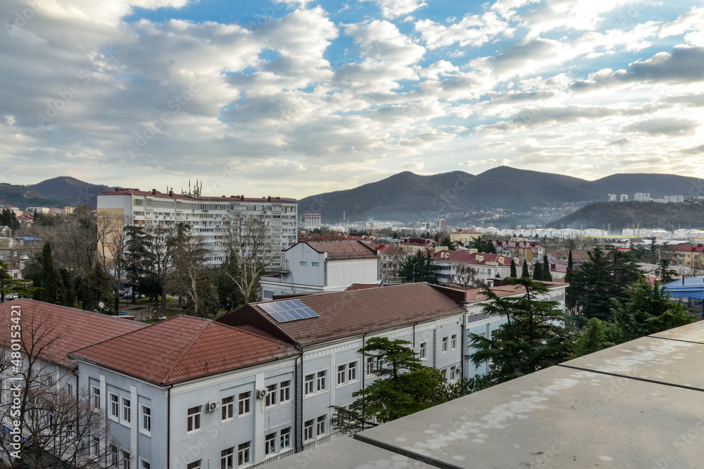 white clouds over roofs of houses and foothills of Northern Caucasus in Tuapse (Krasnodar krai, Russia) 