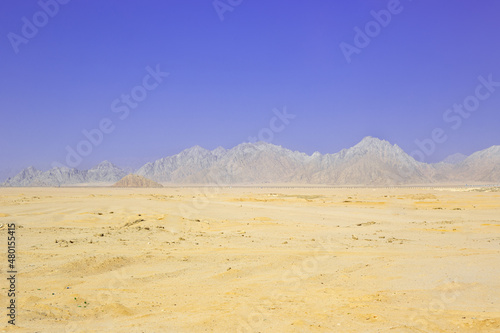Egyptian dessert in sunny day background. African hills and mountains. Tourist Arabian destination. Ecology problems with global warming. © Viktoriia