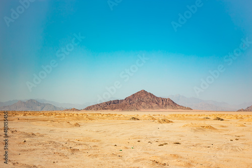 Egyptian dessert in sunny day background. African hills and mountains. Tourist Arabian destination.