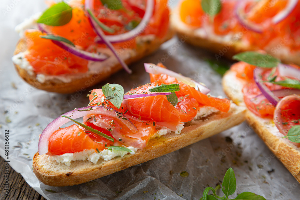 Sandwich with smoked salmon and cream cheese on a crispy baguette Sandwich with smoked salmon and cream cheese on a crispy baguette