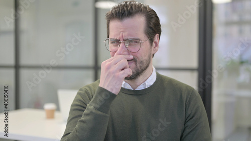 Portrait of Young Businessman Smelling something Bad, Odor