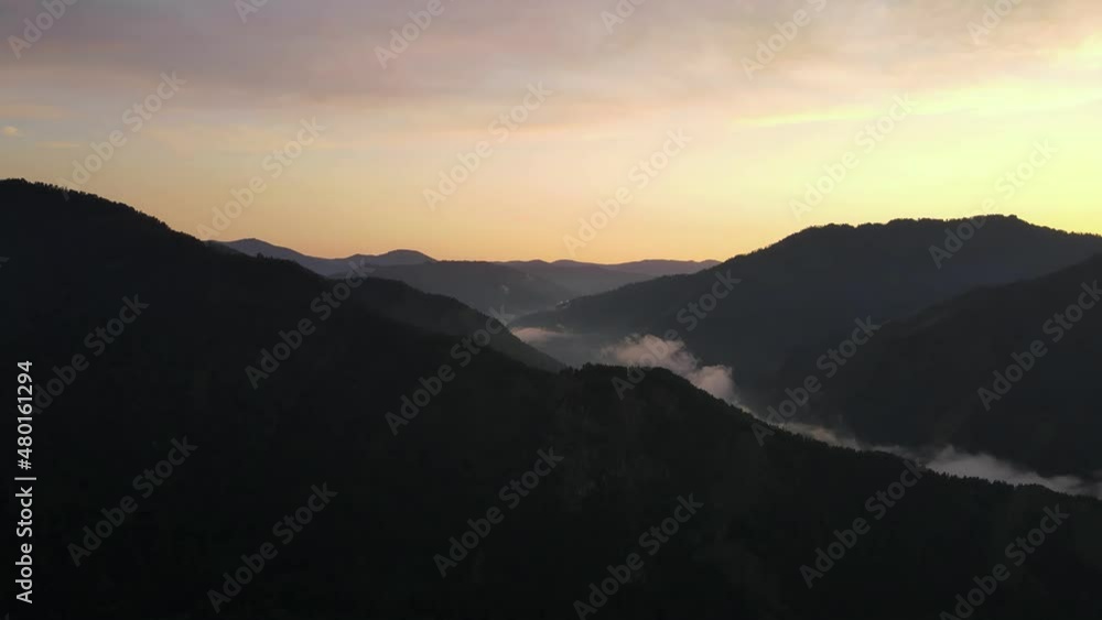 Silhouettes of mountains against the backdrop of the setting sun. Aerial photography of mountain landscapes. Silhouettes of mountains against the backdrop of the setting sun. Aerial photography of mountain landscapes.