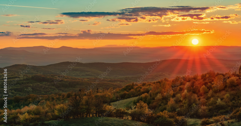 Spring Sunset over green mountains	