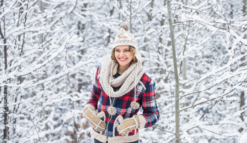 Fototapeta premium Winter admirer. Favorite season. Walk in snowy forest. Cheerful emotional girl having fun outdoors. Winter outfit. Woman wear warm accessories stand in snowy nature. Winter fashion collection