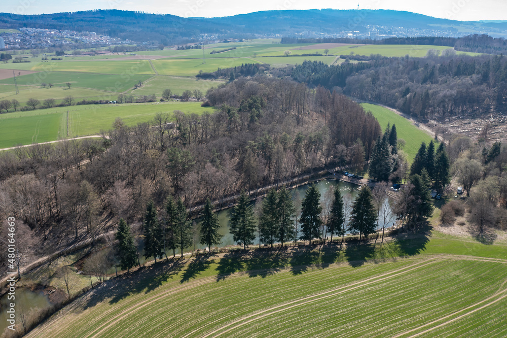 Bird's-eye view of a small fishing pond in the Taunus / Germany in spring 