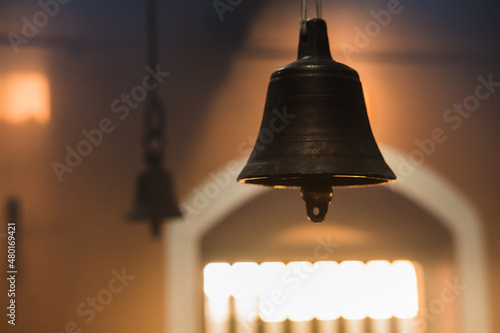 Metal golden bell in a buddhist temple with light. photo