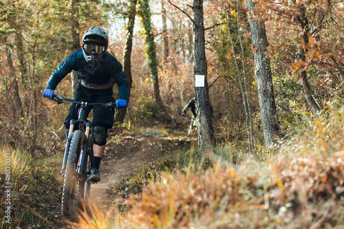 Downhill mtb cyclist descending down mountain track