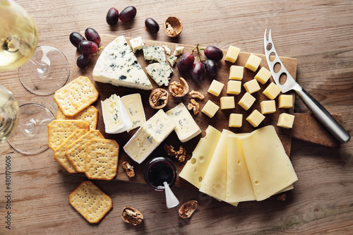 Different arts of cheese with grape on wooden photo