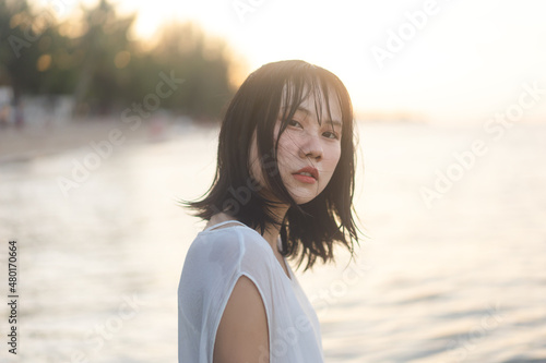 Portrait of asian woman at the beach with wet hair.