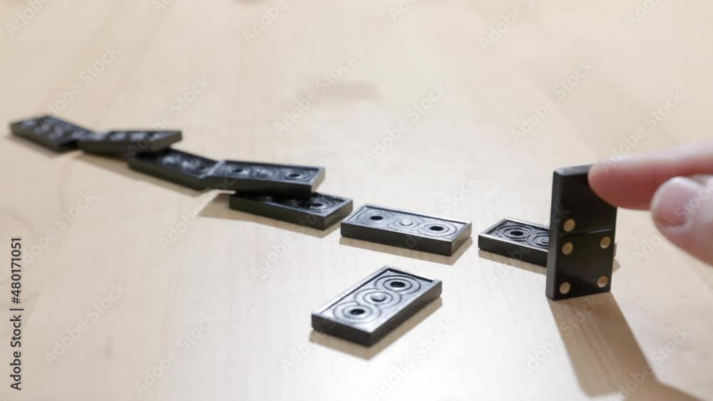 Falling dominoes. Chain reaction, built figure of dominoes falling in slow motion. Falling dominoes. Chain reaction, built figure of dominoes falling in slow motion.