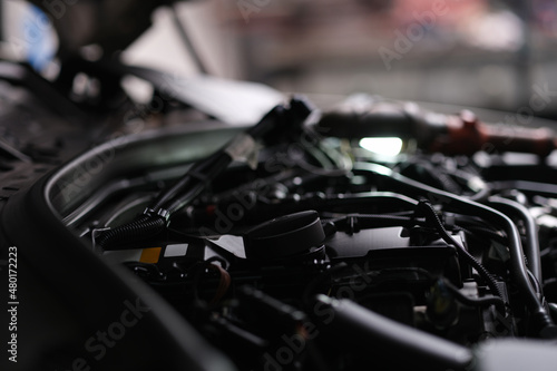 Open engine hood of a automobile, close-up © H_Ko