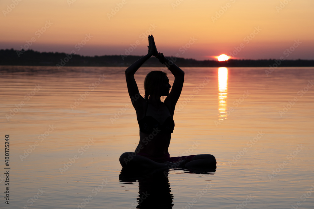 Woman practice Yoga on the beach, Sunset evening