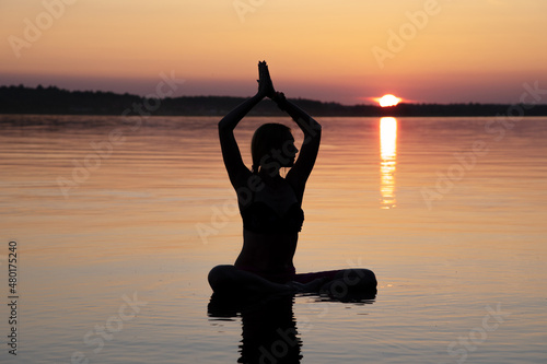 Woman practice Yoga on the beach, Sunset evening © Marina