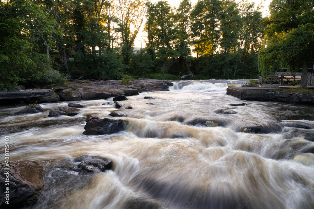 Morrum Salmon river known among fishing enthusiasts around the world because of the salmon fishing. Long exposure during golden hour. Morrum Salmon river known among fishing enthusiasts around the world because of the salmon fishing. Long exposure during golden hour.