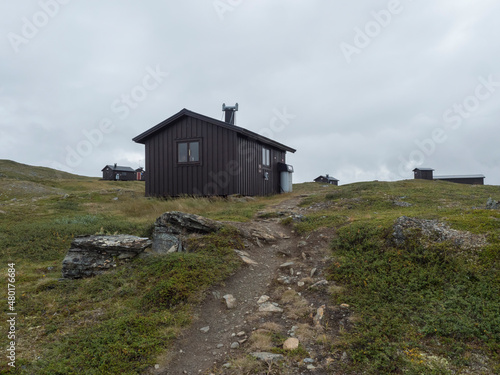 View of mountain huts of STF Duottar fjallstuga cabin at Duottar lake. Lapland landscape Sweden at Padjelantaleden hiking trail. Summer moody sky © Kristyna