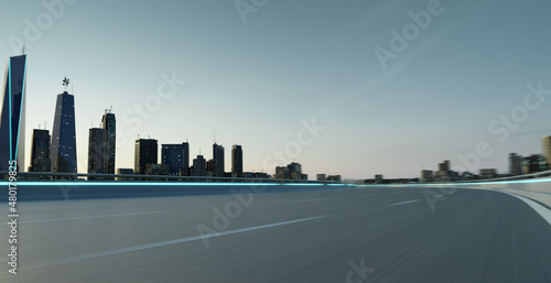 Highway overpass motion blur with city skyline