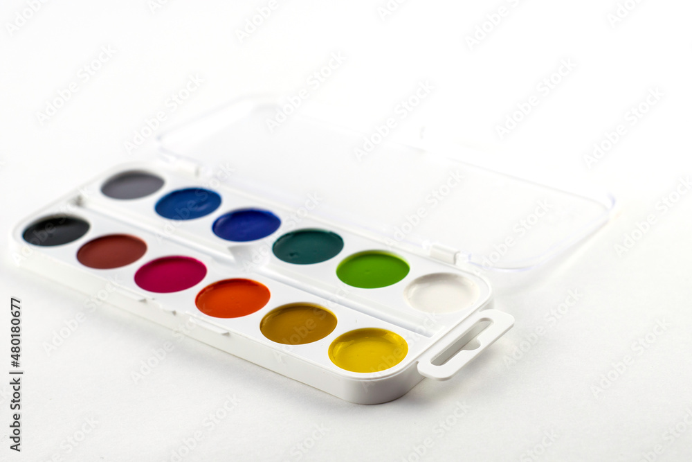 a box with watercolor paints on a white background close-up a box with watercolor paints on a white background close-up