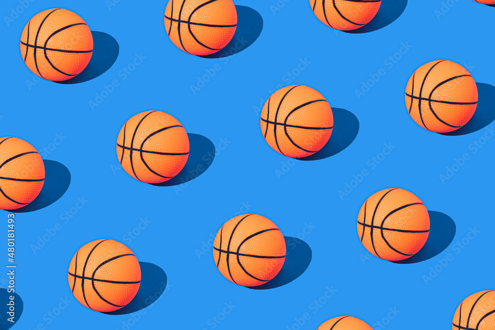 Basketballs on pastel blue background. Minimal basketball pattern. Champion mood. Orange balls pattern. Minimal sport composition.
