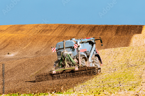 Fotografie, Obraz Truck with a slurry tank fertilizing in the field