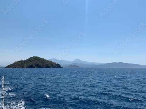 An uninhabited island in the Mediterranean. Islands surrounded by the sea, a quiet harbor for yachts. Seashore against the backdrop of mountains and clear sea. © Сергій Колесніков