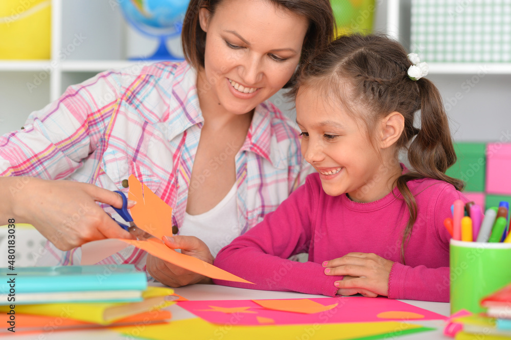 Mother teaches her cute daughter to do craft items Mother teaches her cute daughter to do craft items