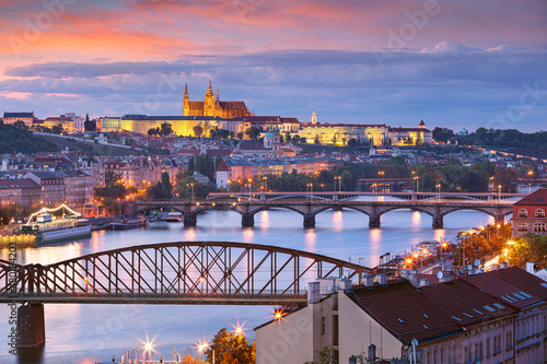 Obraz na płótnie Prague at sunset. Cityscape image of Prague, capital city of Czech Republic with St. Vitus Cathedral and five bridges over Vltava River at autumn sunset. w salonie