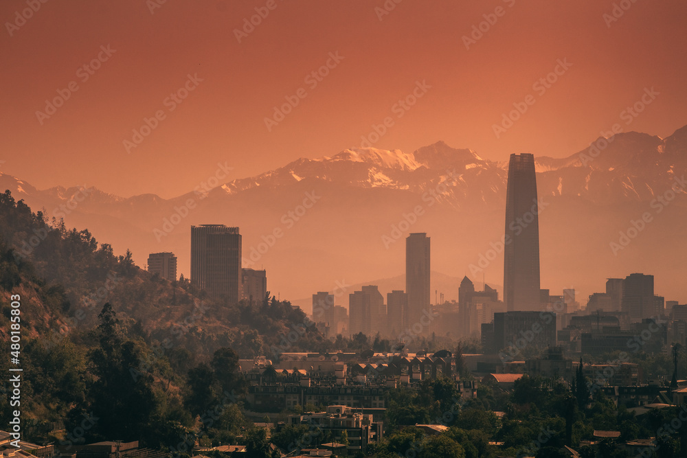 Skyline of Santiago de Chile with skyscrapers at sunrise with the Andes mountain range in the background