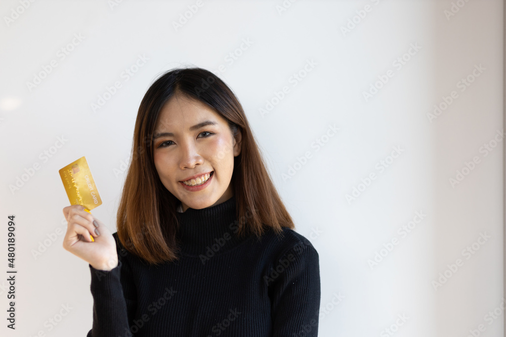 Cheerful smiling Asian woman holding credit card happy. Cheerful smiling Asian woman holding credit card happy.
